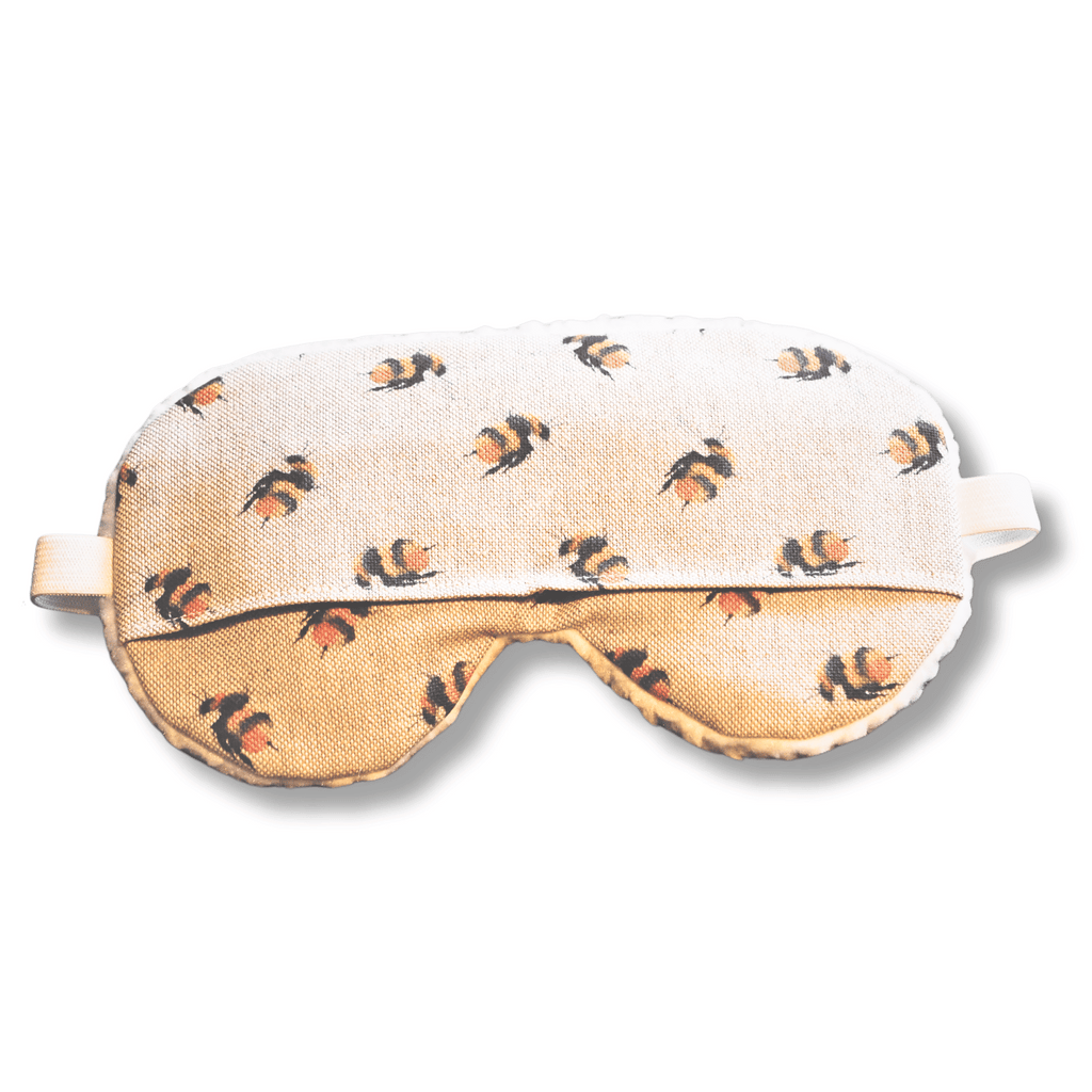 Weighted eye mask with a bee design on a transparent background