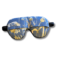 Weighted eye mask with a blue floral design on a transparent background