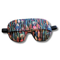 Weighted eye mask with a black floral design on a transparent background