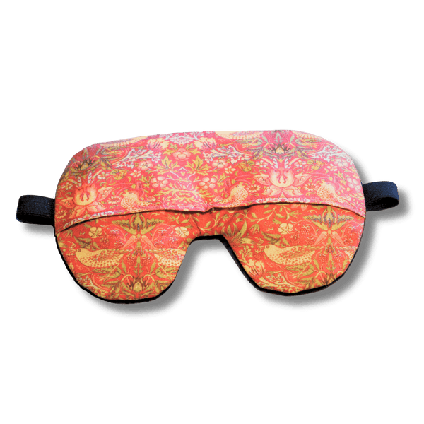 Weighted eye mask with a red bird design on a transparent background