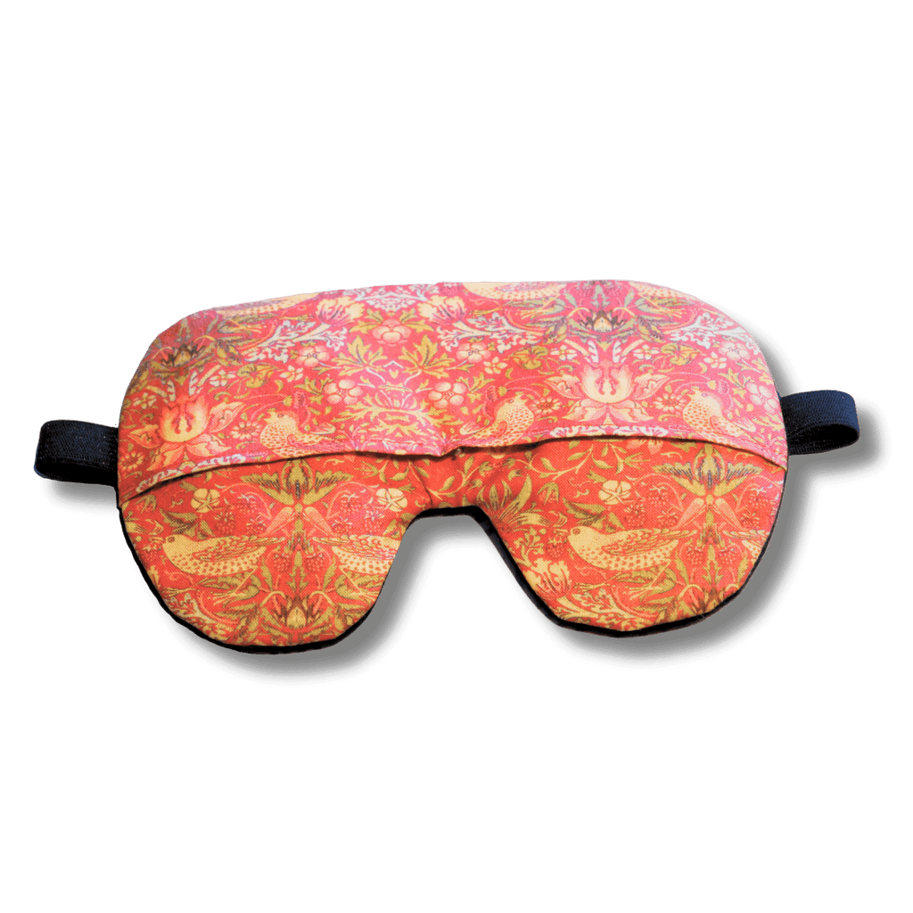 Weighted eye mask with a red bird design on a transparent background