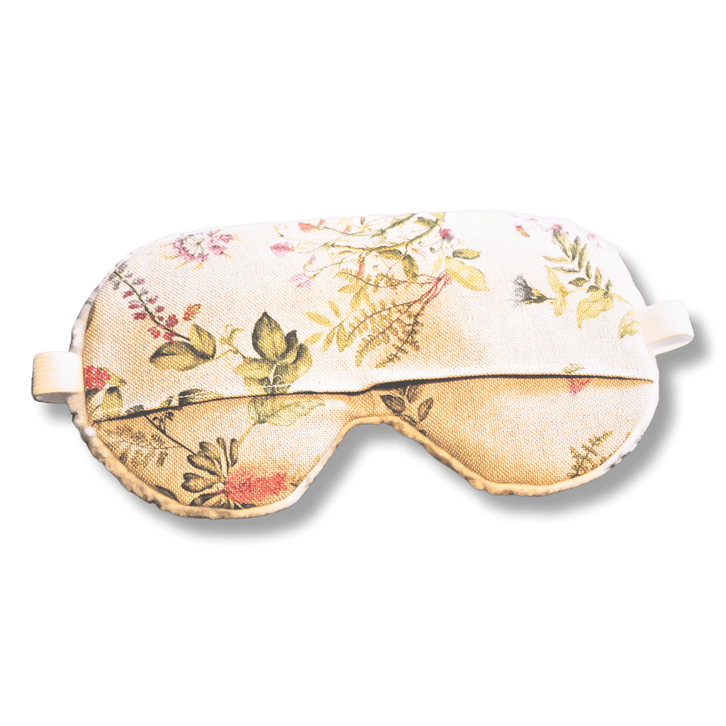 Weighted eye mask with a floral design on a transparent background