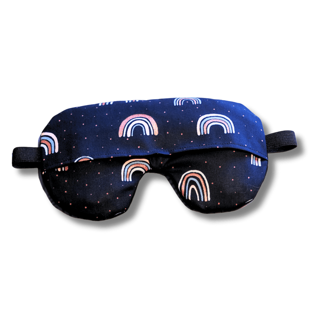 Weighted eye mask with a navy rainbow design on a transparent background