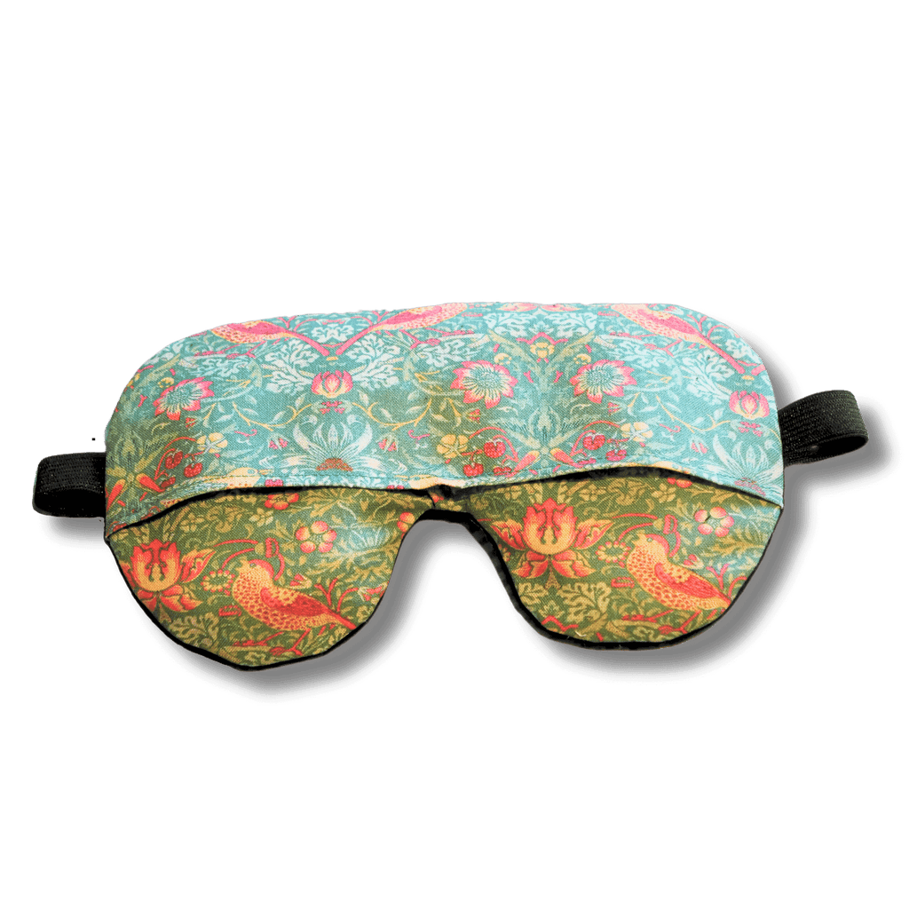 Weighted eye mask with a green bird design on a transparent background