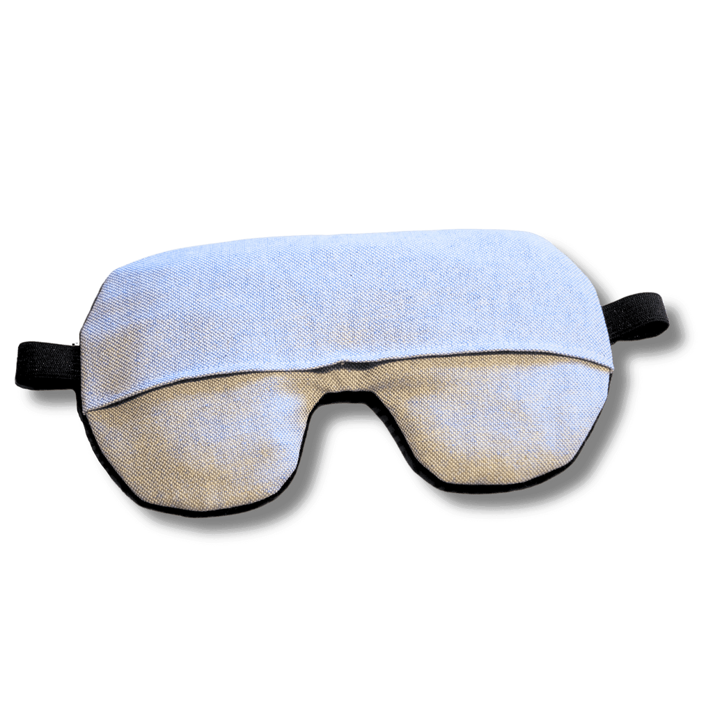 Weighted eye mask with a pastel blue design on a transparent background