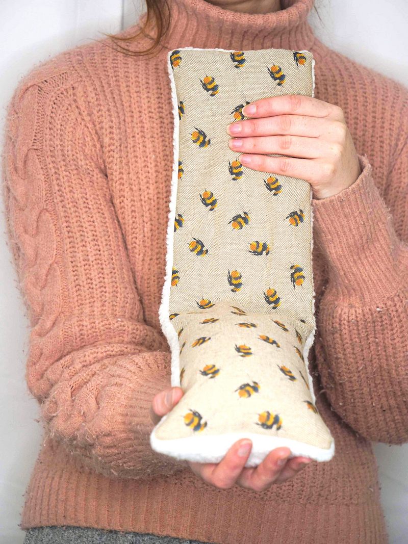 Girl holding a wheat bag bees