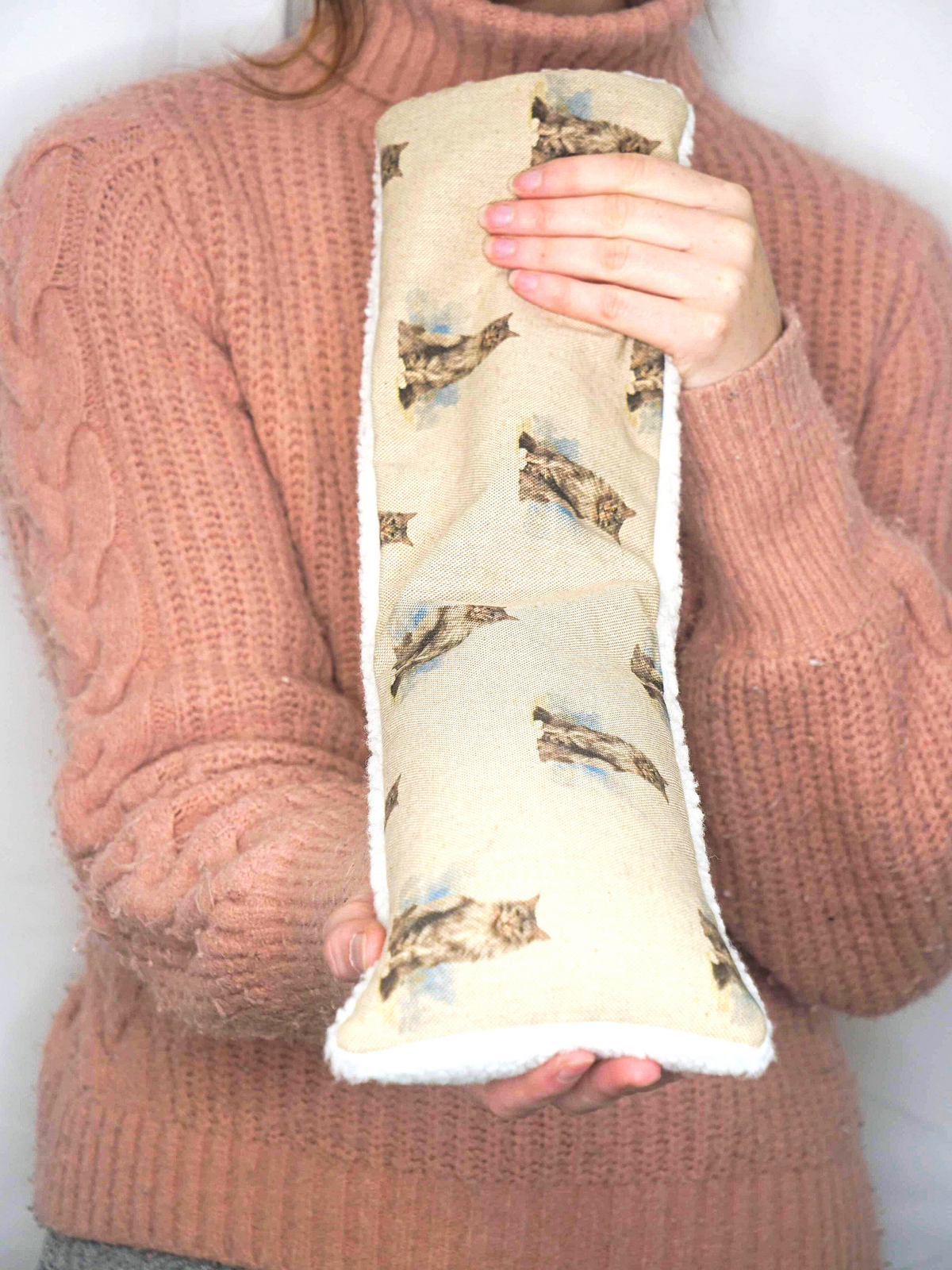 Girl holding wheat bag with cat design