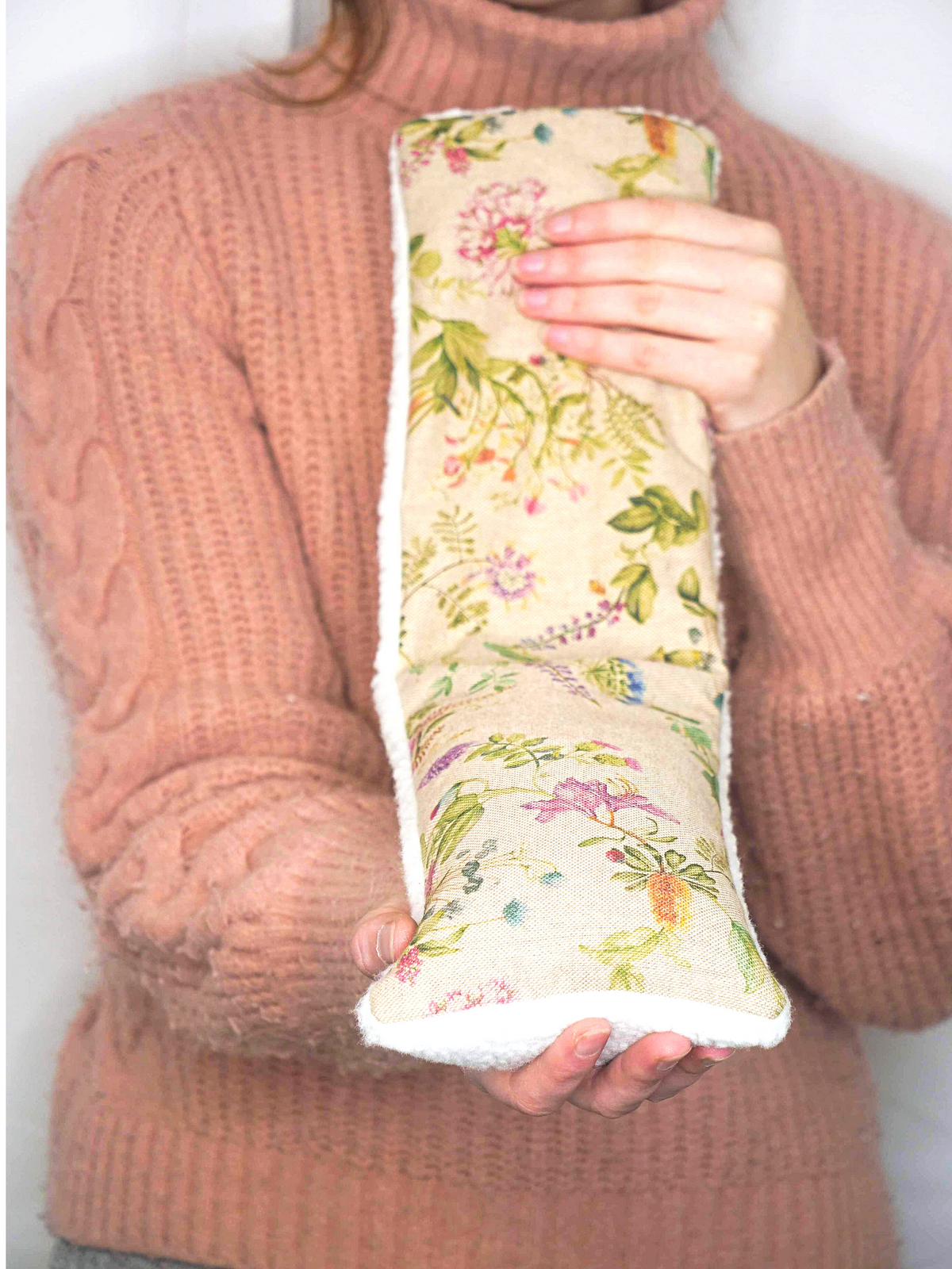 Girl holding wheat bag with floral design