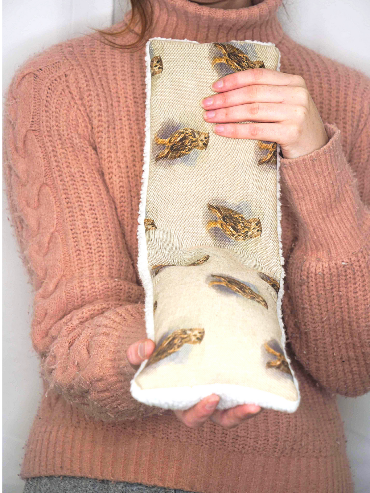 Girl holding wheat bag with owl design