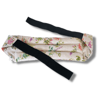 Wearable microwave wheat bag belt with a floral design on a transparent background